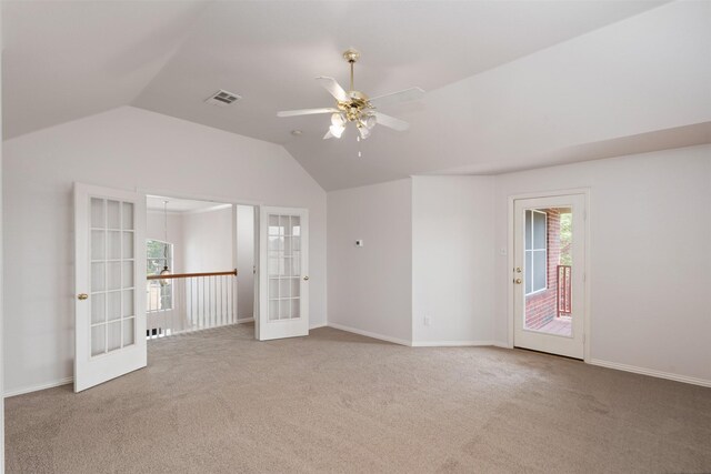 carpeted empty room featuring lofted ceiling, visible vents, a ceiling fan, french doors, and baseboards