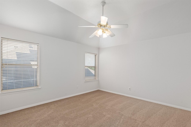 empty room with baseboards, a ceiling fan, and carpet