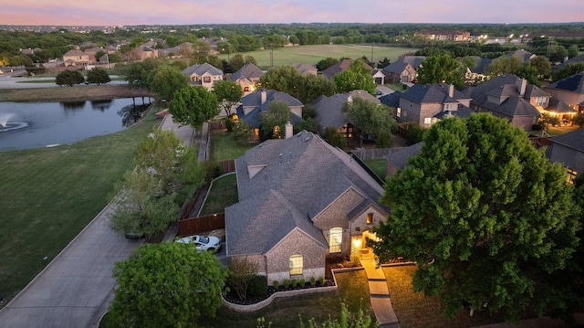 drone / aerial view featuring a residential view and a water view