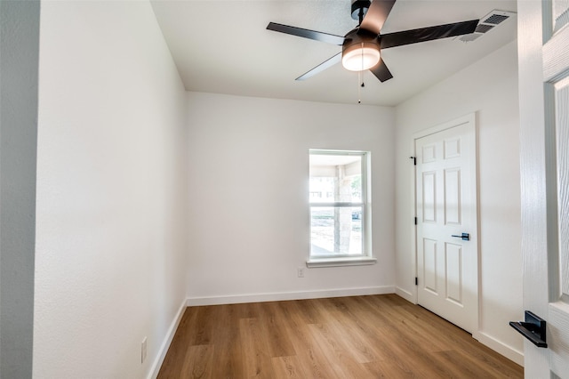 unfurnished bedroom with baseboards, visible vents, a ceiling fan, and light wood-style flooring