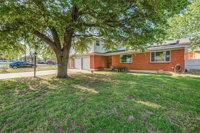5601 Jane Anne St, Haltom City, TX 76117 - ranch-style home featuring concrete driveway, roof mounted solar panels, brick siding, and a front lawn