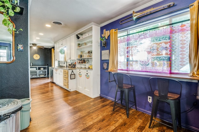 5601 Jane Anne St, Haltom City, TX 76117 - bar featuring a sink, wood finished floors, visible vents, and plenty of natural light