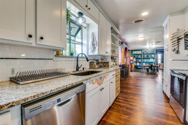 5601 Jane Anne St, Haltom City, TX 76117 - kitchen featuring dark wood finished floors, visible vents, a sink, tasteful backsplash, and appliances with stainless steel finishes