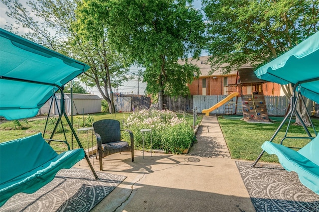 5601 Jane Anne St, Haltom City, TX 76117 - view of patio / terrace with a fenced backyard and a playground