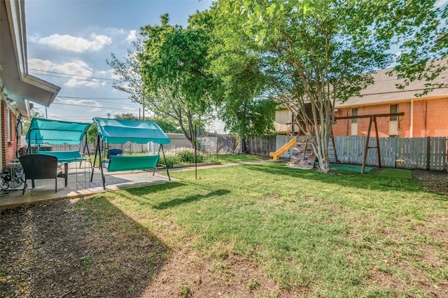 5601 Jane Anne St, Haltom City, TX 76117 - view of yard with a fenced backyard, a patio area, and a playground
