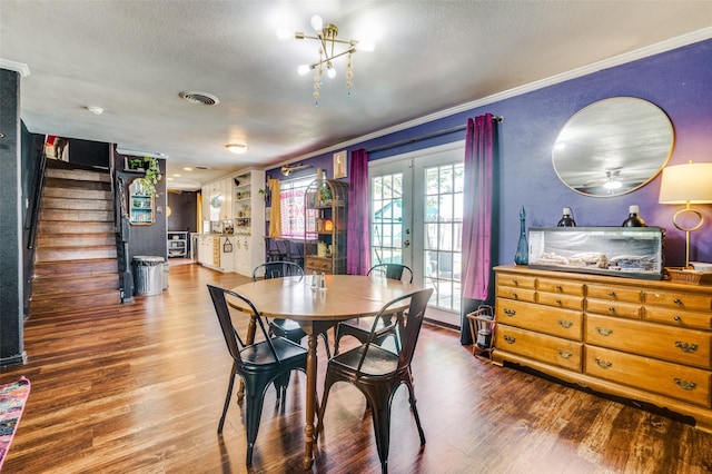 5601 Jane Anne St, Haltom City, TX 76117 - dining space featuring wood finished floors, visible vents, french doors, crown molding, and stairs