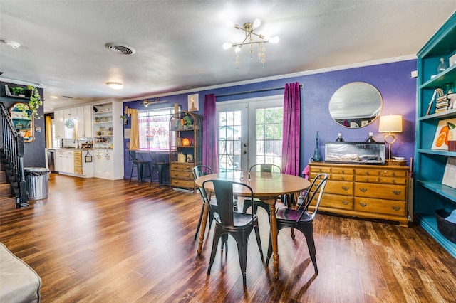 5601 Jane Anne St, Haltom City, TX 76117 - dining area with stairway, french doors, dark wood-type flooring, crown molding, and a chandelier