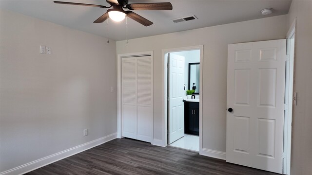 2904 Chestnut Ave, Fort Worth, TX 76106 - unfurnished bedroom with a closet, baseboards, dark wood finished floors, ensuite bath, and visible vents