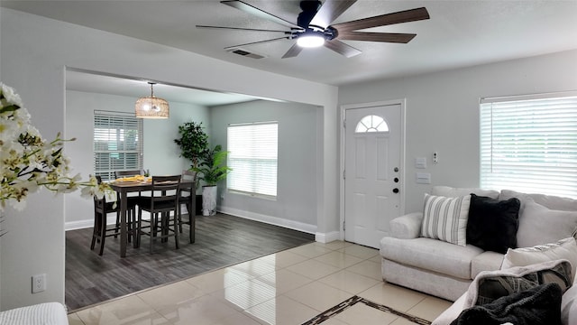 2904 Chestnut Ave, Fort Worth, TX 76106 - living area with visible vents, baseboards, ceiling fan, and light tile patterned floors