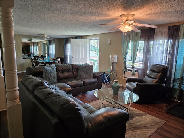 living room featuring a ceiling fan, wood finished floors, and a textured ceiling