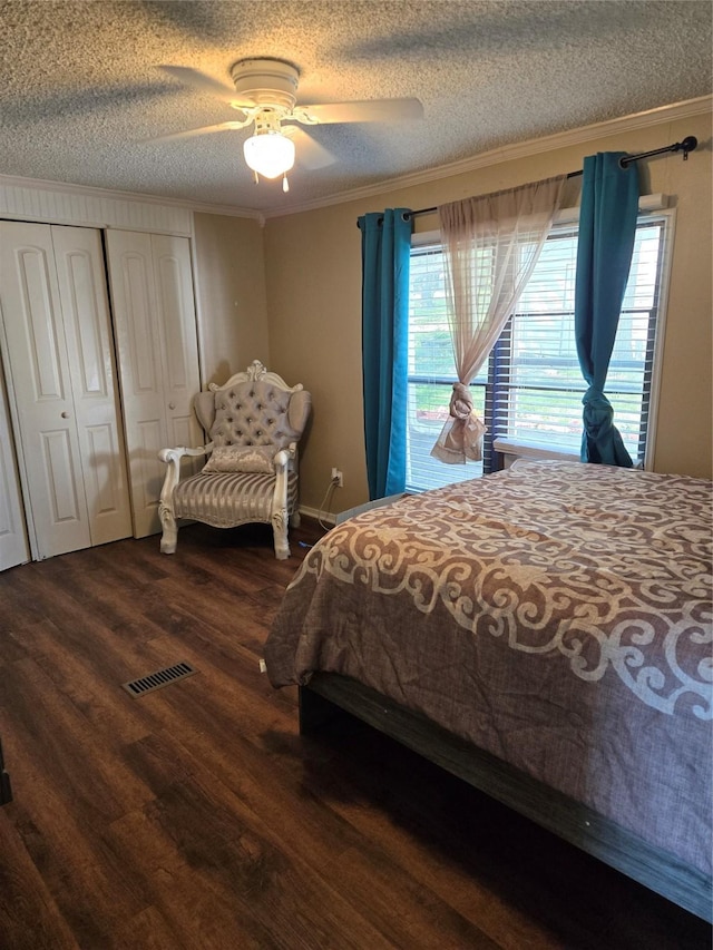 bedroom featuring wood finished floors, a textured ceiling, crown molding, and multiple windows