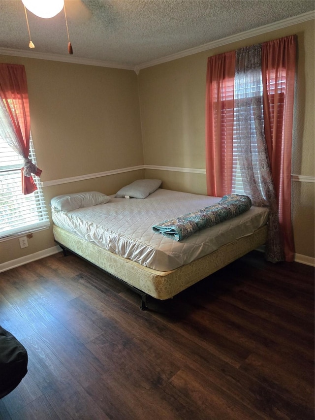 bedroom featuring wood finished floors, baseboards, and ornamental molding