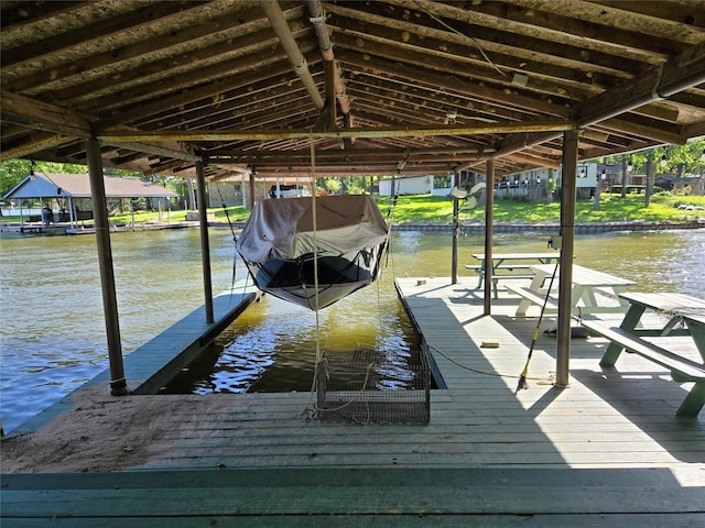 view of dock with boat lift and a water view