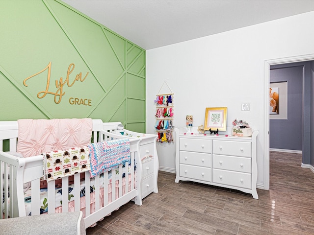 bedroom featuring baseboards and wood finished floors