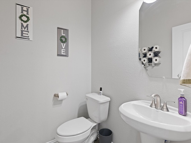 bathroom featuring toilet and a sink