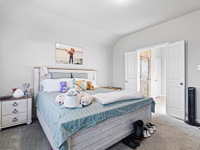 carpeted bedroom featuring connected bathroom and vaulted ceiling