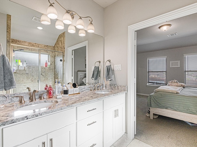 bathroom featuring visible vents, a shower stall, connected bathroom, and a sink