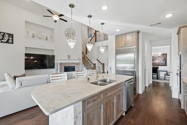 14329 Home Trl, Fort Worth, TX 76262 - kitchen featuring a sink, appliances with stainless steel finishes, visible vents, open floor plan, and a fireplace