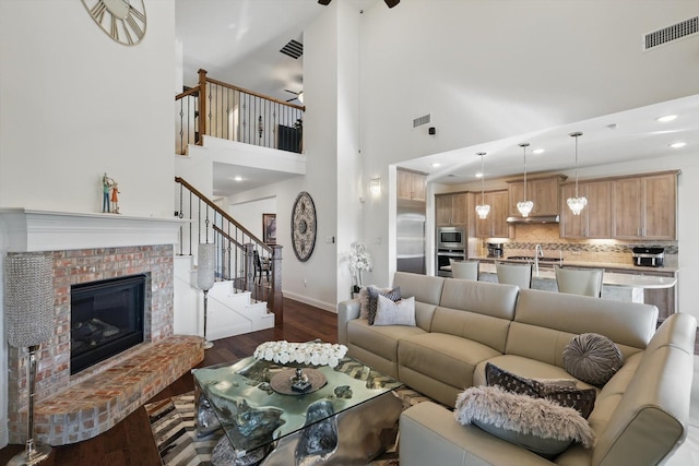 14329 Home Trl, Fort Worth, TX 76262 - living area with visible vents, ceiling fan, dark wood-style floors, baseboards, and stairs