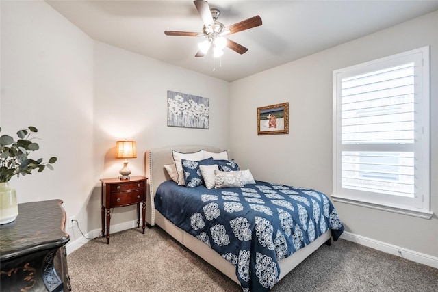 carpeted bedroom with a ceiling fan and baseboards