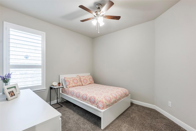 carpeted bedroom with baseboards and a ceiling fan
