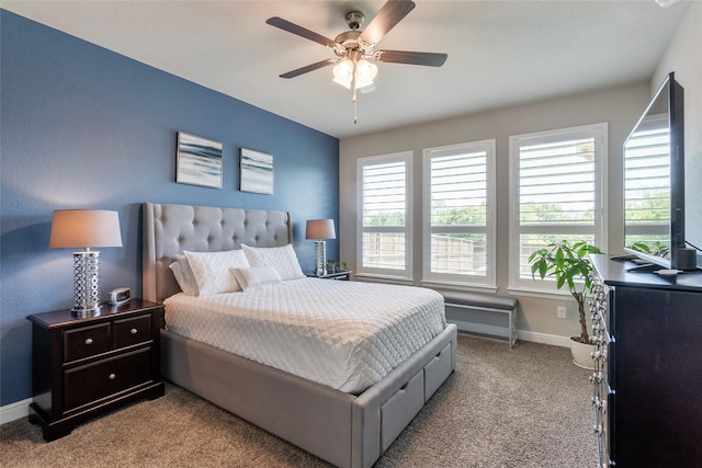 carpeted bedroom with a ceiling fan and baseboards