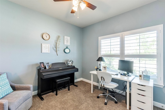 home office featuring light colored carpet, ceiling fan, and baseboards