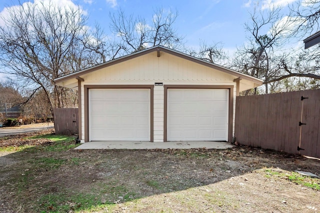 detached garage featuring fence
