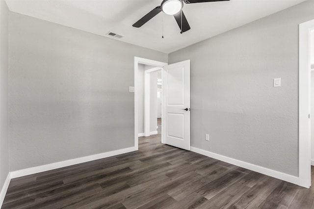 4227 Harvey Dr, Mesquite, TX 75150 - empty room featuring a ceiling fan, dark wood finished floors, and baseboards