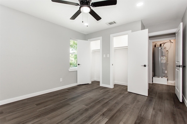 4227 Harvey Dr, Mesquite, TX 75150 - unfurnished bedroom with water heater, dark wood-type flooring, baseboards, and ceiling fan