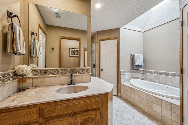bathroom featuring tile patterned floors, a stall shower, a bath, vanity, and visible vents