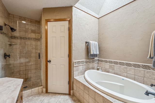 bathroom featuring a bath, tile patterned floors, a textured ceiling, and a stall shower