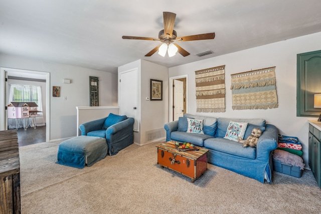 living room with baseboards, visible vents, carpet floors, and ceiling fan