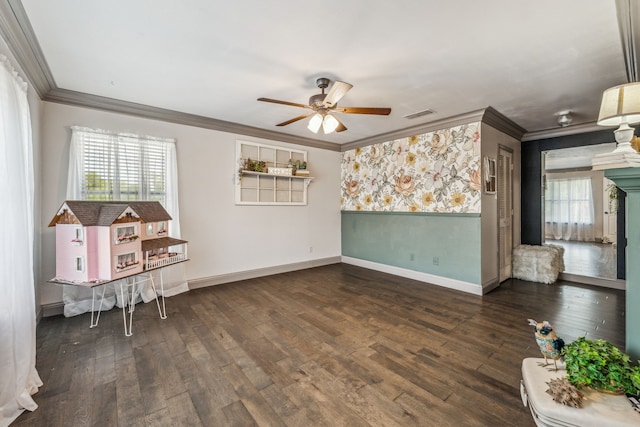 interior space with hardwood / wood-style flooring, a ceiling fan, baseboards, and ornamental molding