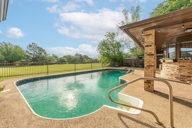 view of pool with a fenced backyard, a yard, a patio area, and a fenced in pool