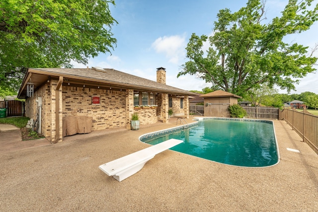 view of pool with a fenced in pool, a fenced backyard, a patio, and a diving board