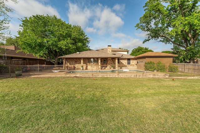 back of house featuring a chimney, fence private yard, and a yard
