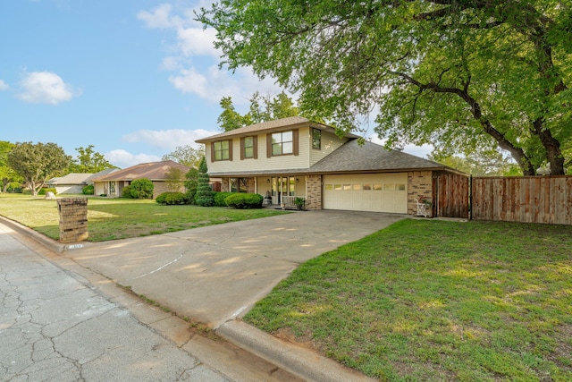 traditional-style house featuring a garage, concrete driveway, fence, a porch, and a front yard