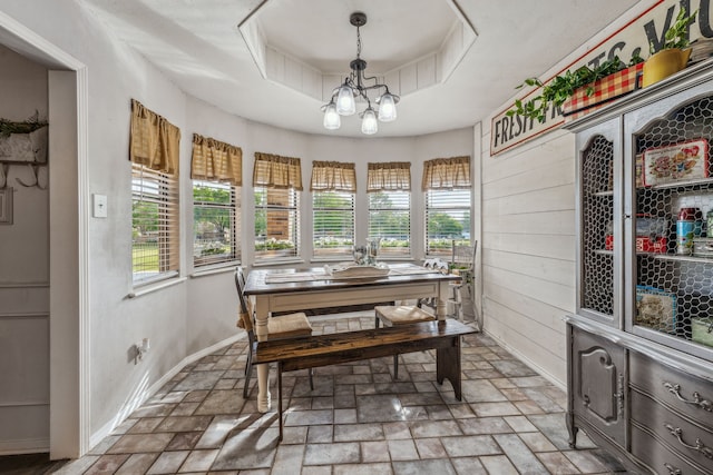 sunroom with a notable chandelier and a healthy amount of sunlight