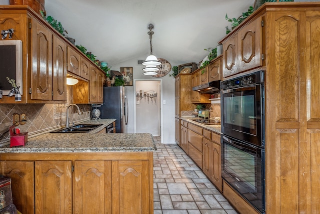 kitchen with under cabinet range hood, a sink, decorative backsplash, black appliances, and brown cabinetry