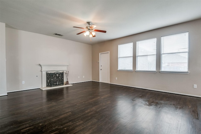 504 Ame Ln, Royse City, TX 75189 - unfurnished living room with ceiling fan, wood finished floors, a fireplace with raised hearth, and baseboards