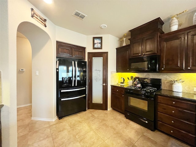 kitchen featuring black appliances, backsplash, dark brown cabinets, and visible vents