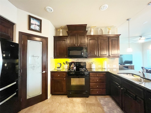 kitchen featuring a sink, tasteful backsplash, dark brown cabinetry, ceiling fan, and black appliances