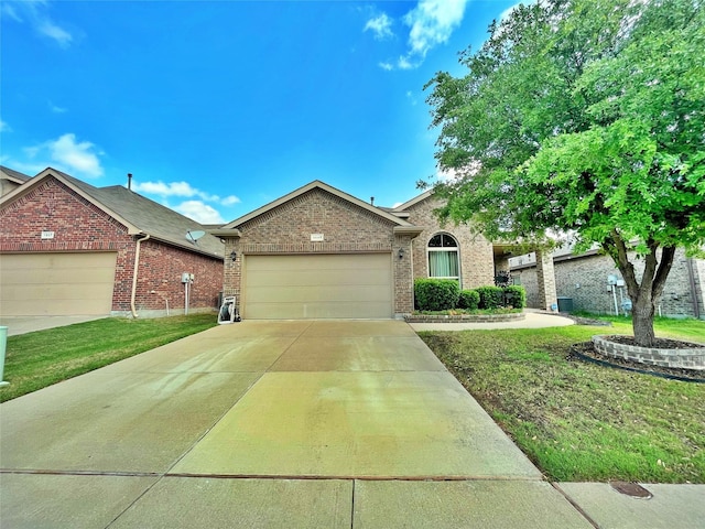 ranch-style home featuring concrete driveway, brick siding, a front yard, and a garage