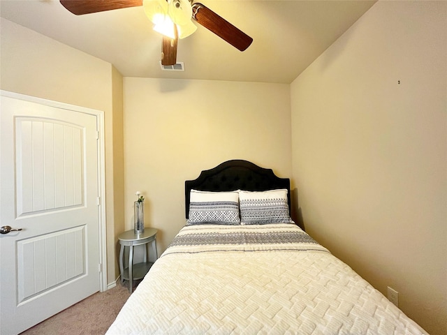 carpeted bedroom with a ceiling fan and visible vents