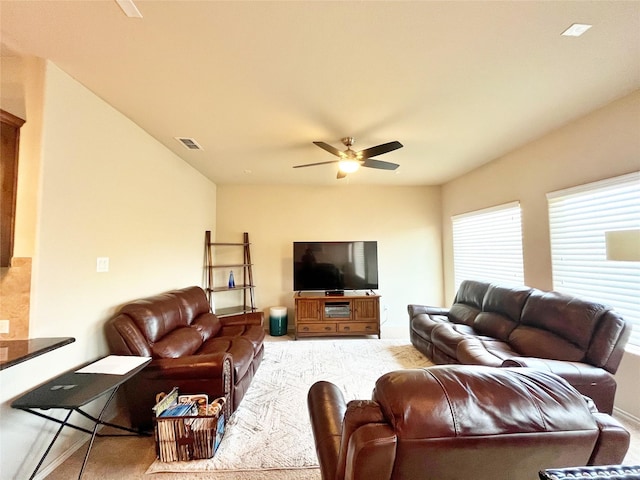 living room featuring a ceiling fan, visible vents, and carpet floors