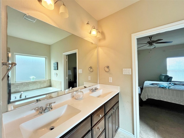 ensuite bathroom with ensuite bathroom, a sink, and a healthy amount of sunlight