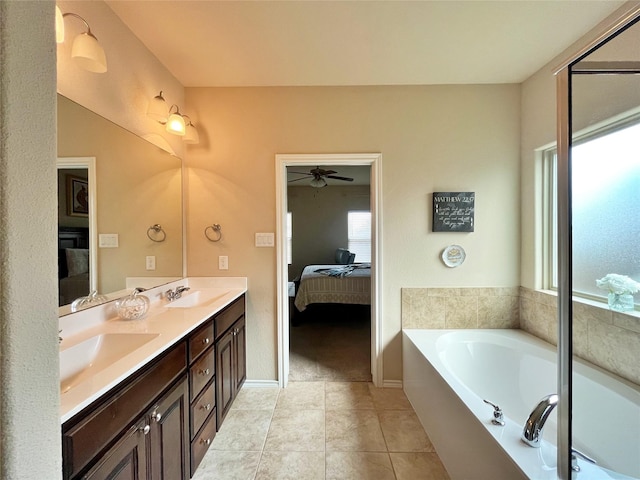 ensuite bathroom with a sink, double vanity, tile patterned flooring, a garden tub, and connected bathroom