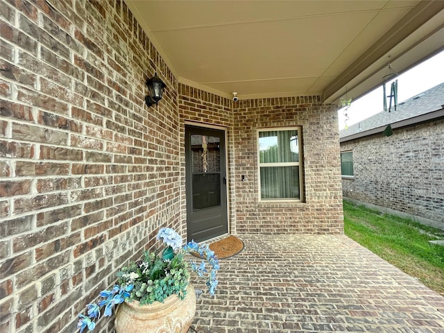property entrance featuring brick siding