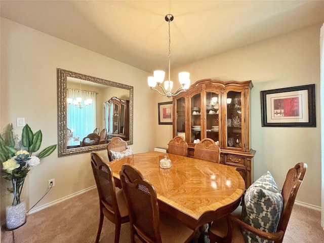 dining area with carpet, baseboards, and a notable chandelier